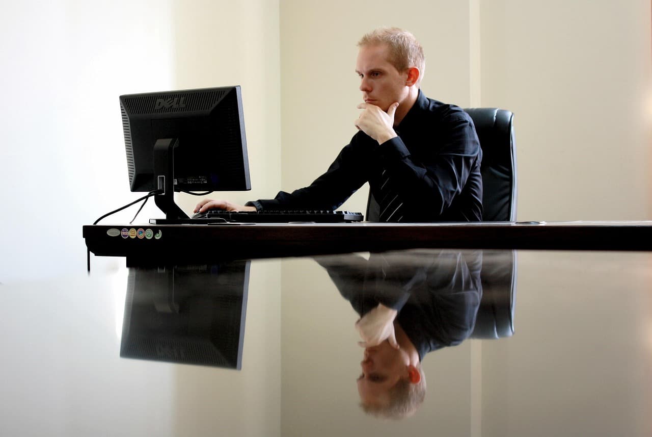 Executive at a desk with a computer, illustrating IBKR Autonomous Trading