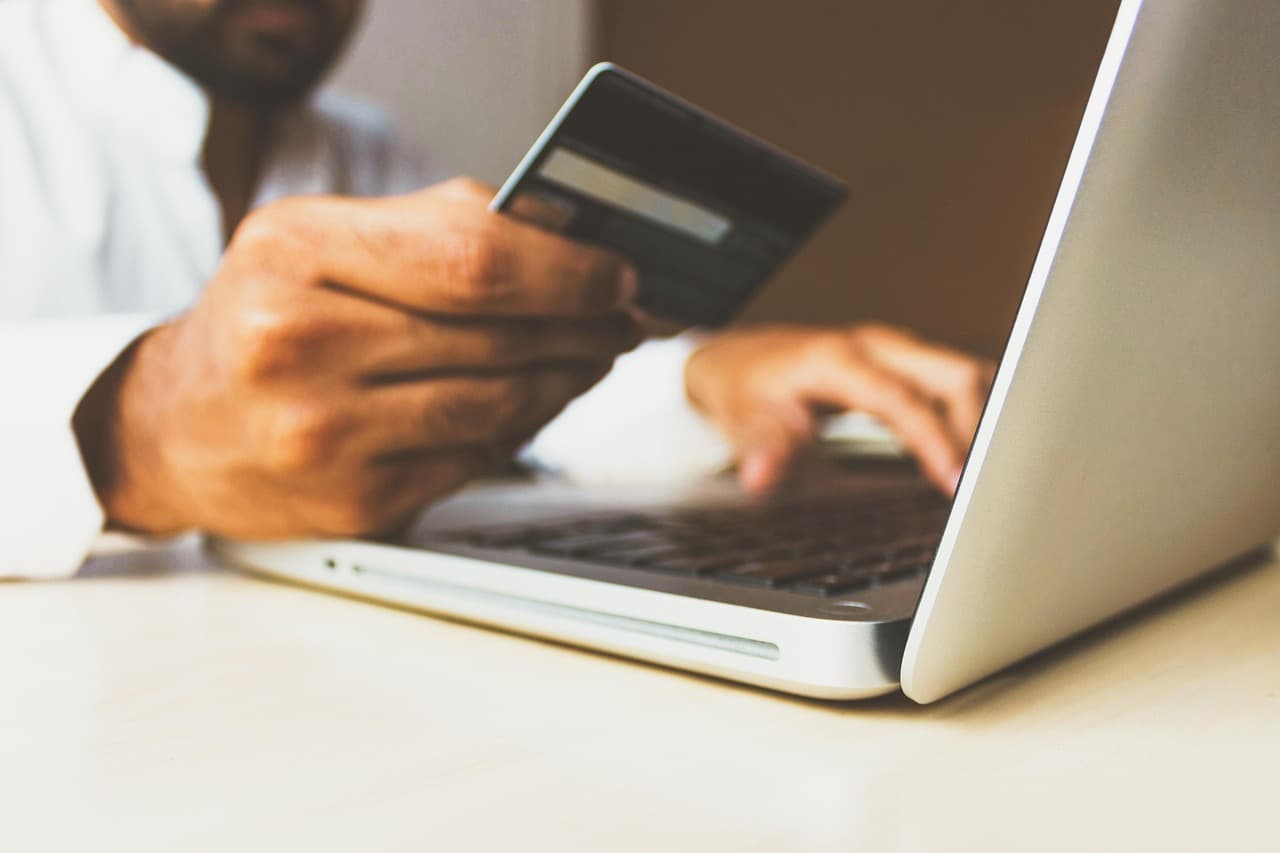 A business user paying online with a card on a laptop, illustrating Newline Visa corporate cards for fintechs