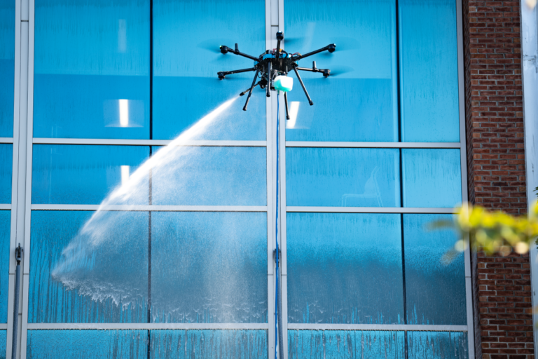 Window washing drones cleaning high-rise building exterior